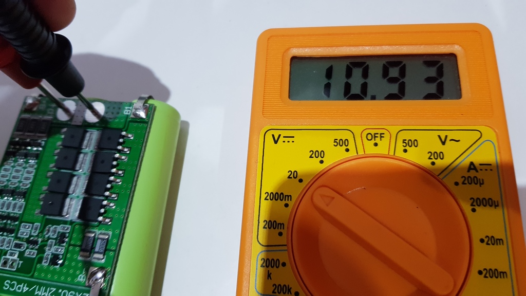 Multimeter measuring a battery protection board